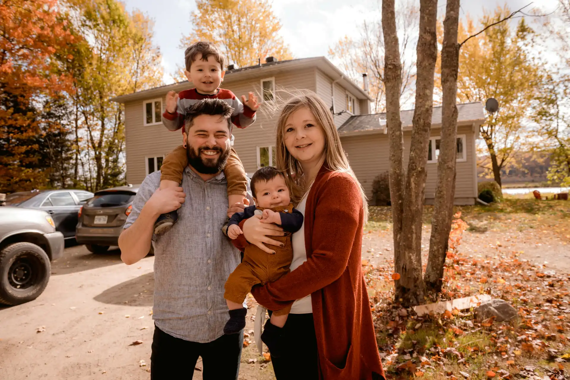 A happy family outdoors in the fall, staying warm with a reliable home heating system.