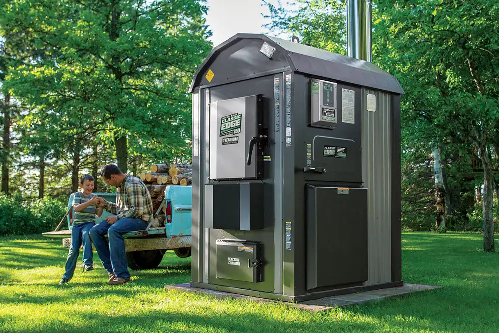Efficient and durable outdoor wood boiler in a grassy yard
